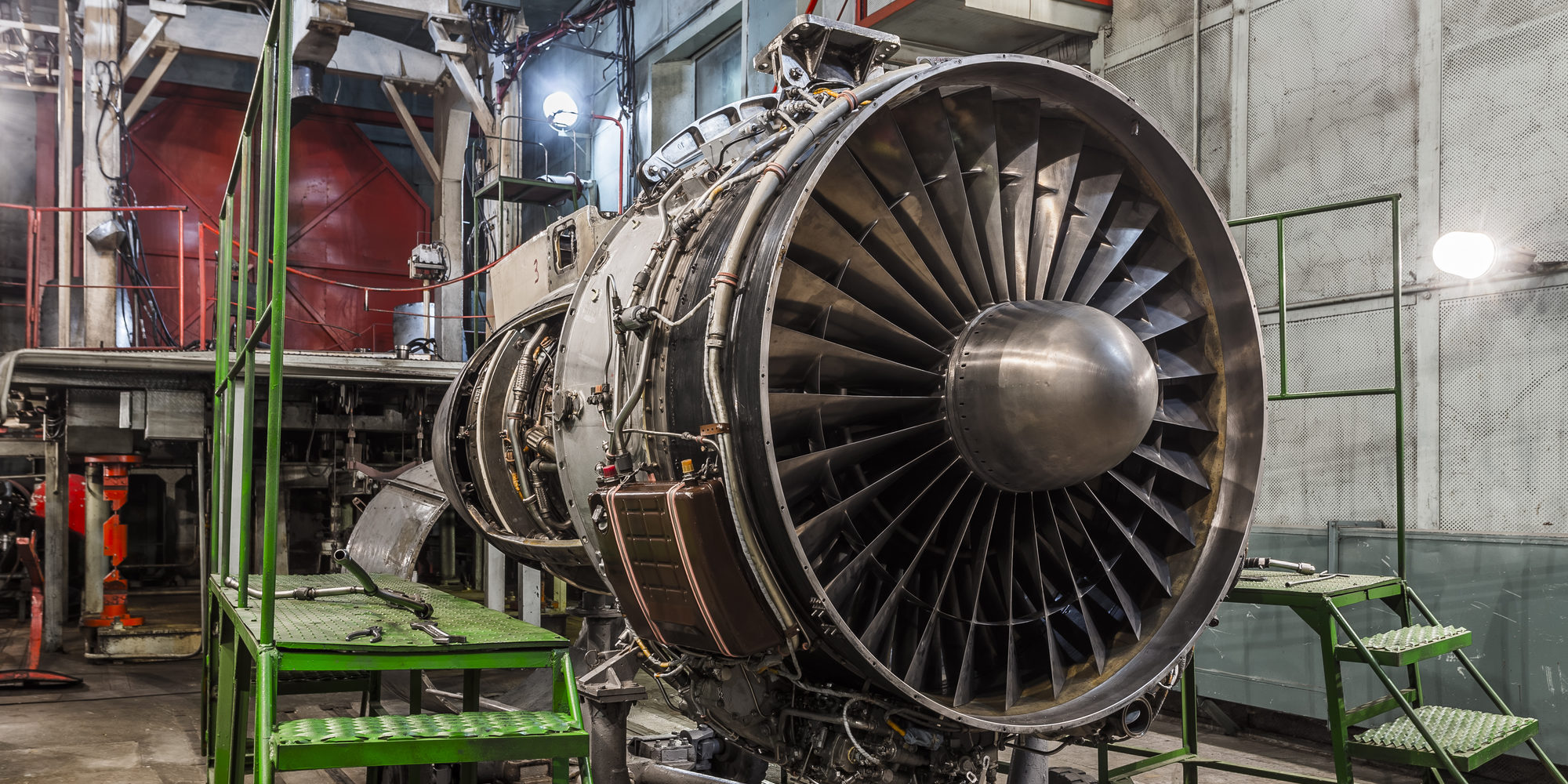Airplane gas turbine engine detail in aviation hangar. Plane rotor under heavy maintenance.