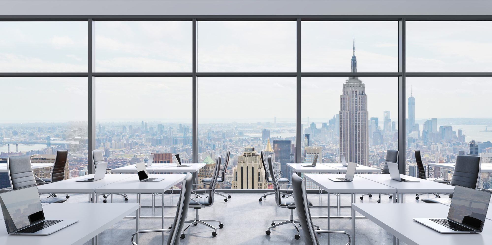 Workplaces in a modern panoramic office, New York city view from the windows. Open space. White tables and black leather chairs. A concept of financial consulting services. 3D rendering.